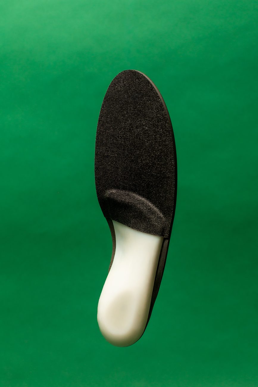 A ReLEAF orthotic from the side, showing the full height of the arch shell.