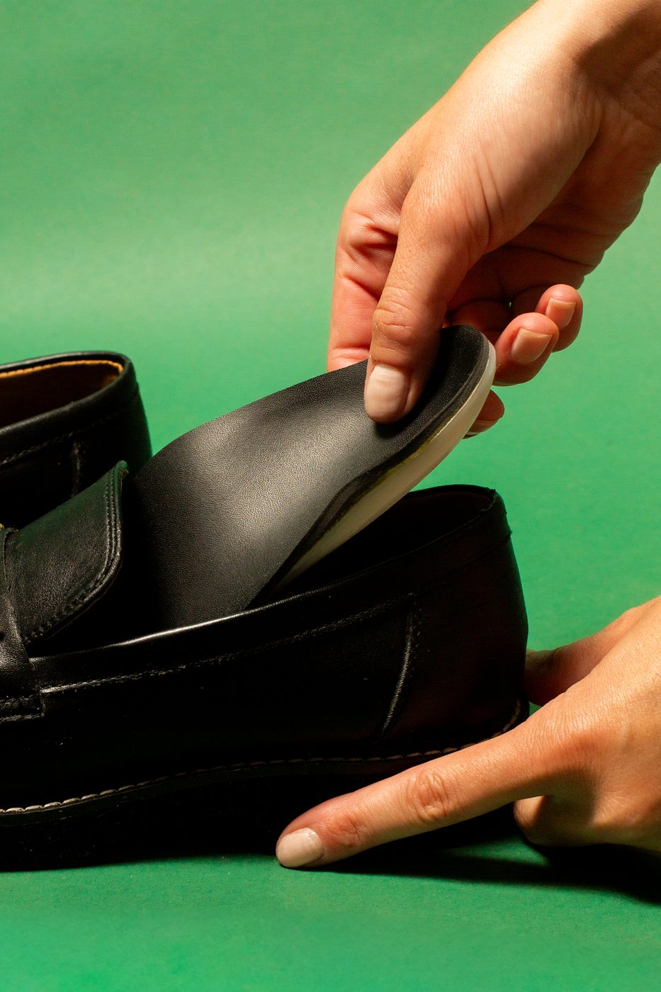 Hands pressing a ReLEAF shell into a shoe.